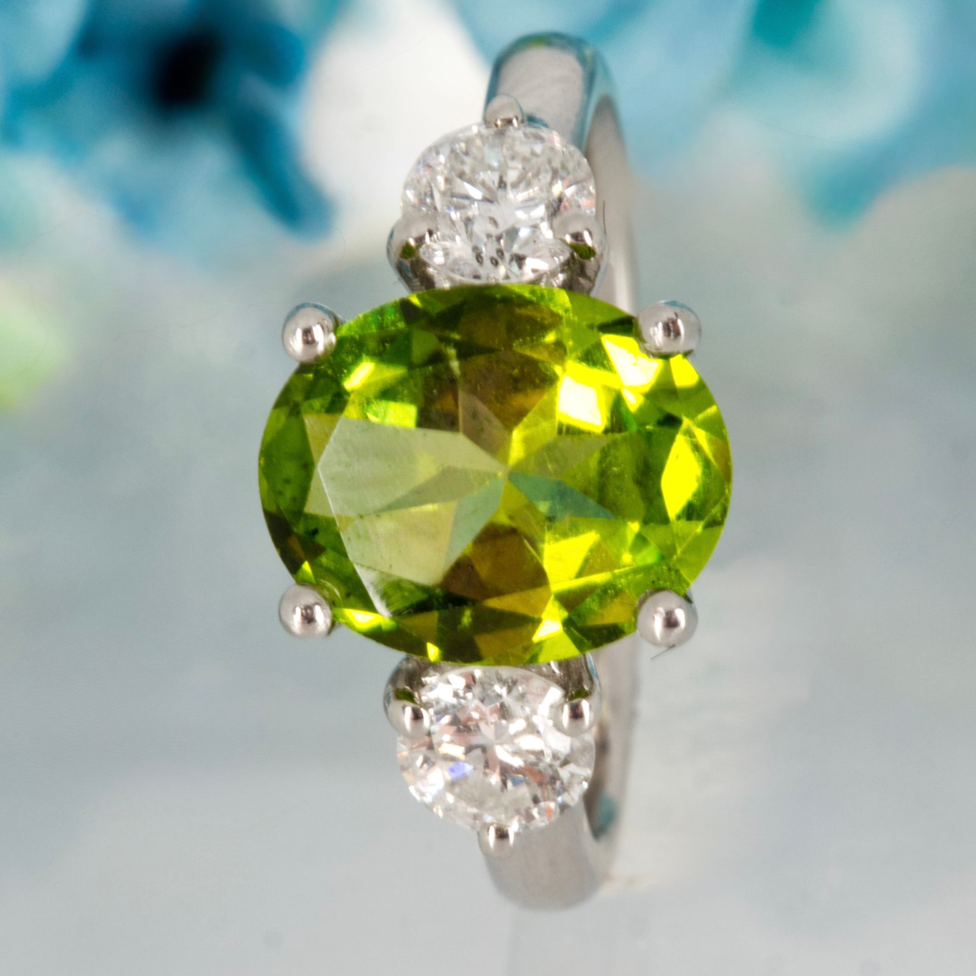 Platinum Oval Cut Peridot & Round Brilliant Cut Diamond Trilogy Ring