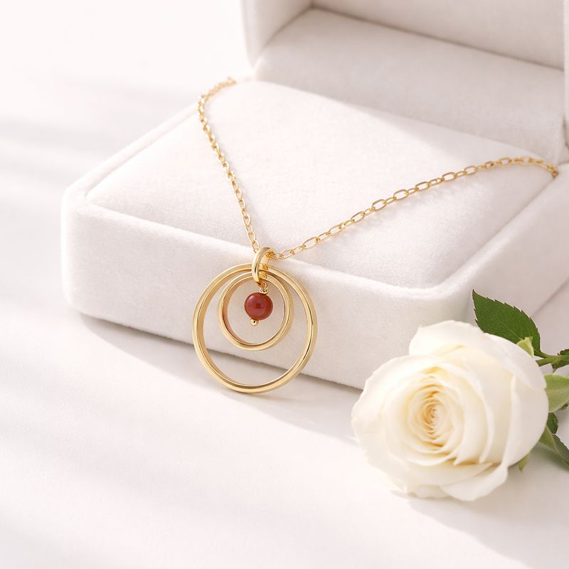 Gold-plated silver pendant with two circles and natural pearl