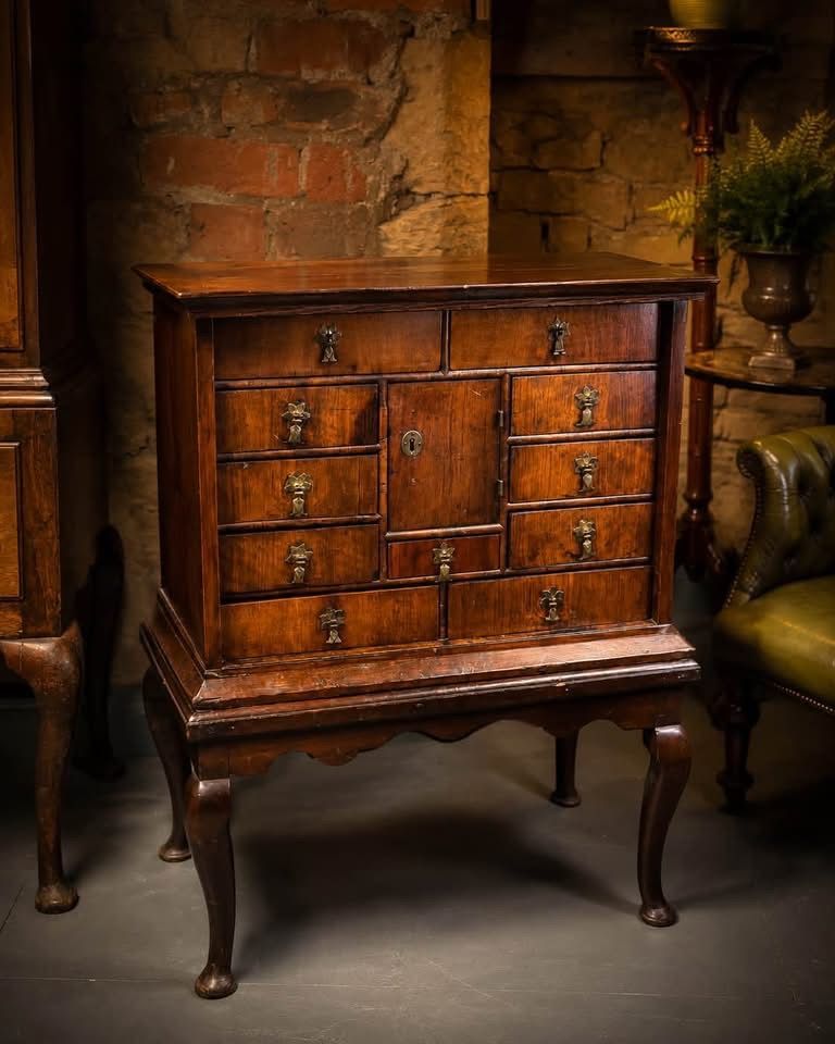 Small Queen Anne Walnut Cabinet on Later Stand Front view of the Queen Anne walnut cabinet with brass fittings