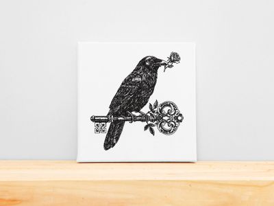 Embroidery of a raven holding a rose while perched on a skeleton key, mounted on a white stretched canvas frame.
