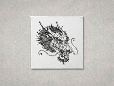 Black machine embroidery of a Chinese Dragon head on a white canvas with a grey background.