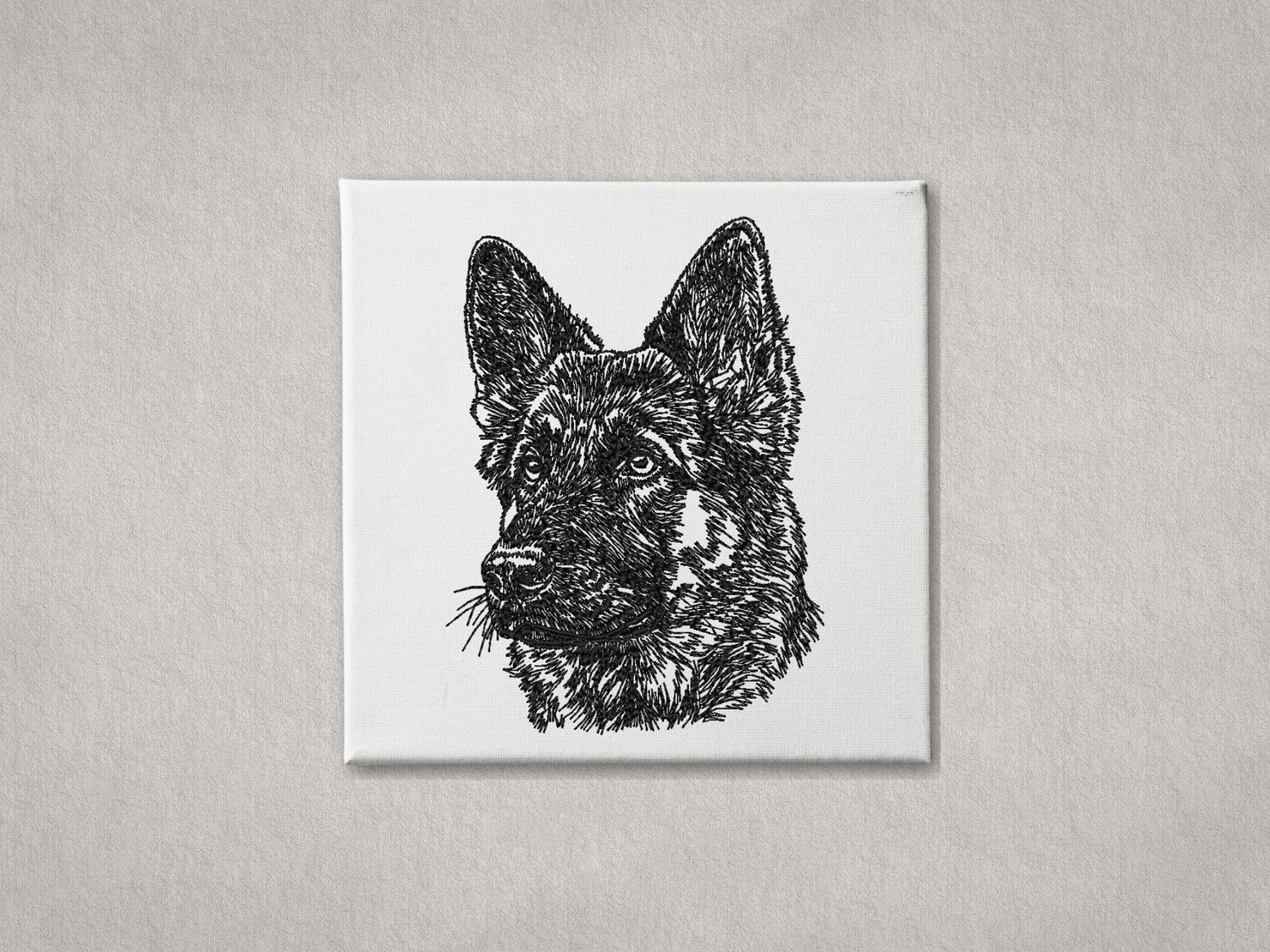 Black machine embroidery of a German Shepherd portrait on a white stretched canvas frame.