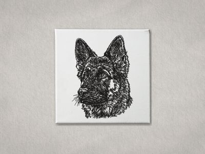Black machine embroidery of a German Shepherd portrait on a white stretched canvas frame.