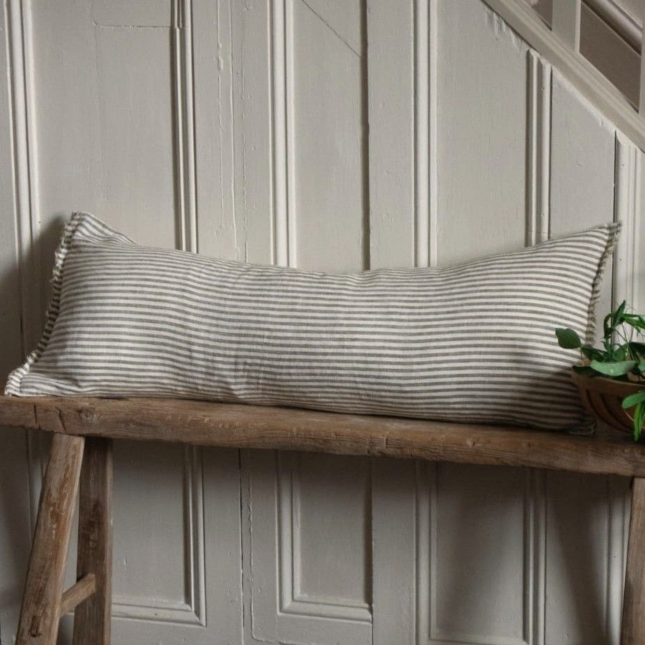 Esmee Olive Stripe Bolster cushion the ideal companion for a rustic wooden bench or window seat. A true statement piece.