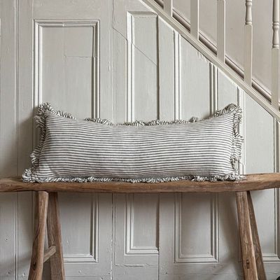 Hallie Olive Stripe Linen Bolster Cushion with a stonewashed vintage feel and subtle ruffled edging. The perfect bench warmer
