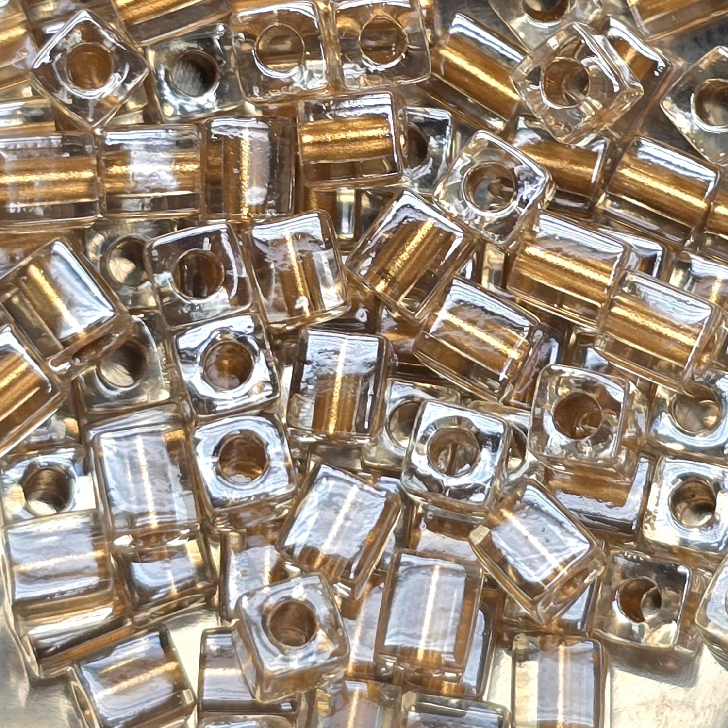 SB4-234: Miyuki Metallic Gold Lined Crystal - 4mm Square/Cube Beads