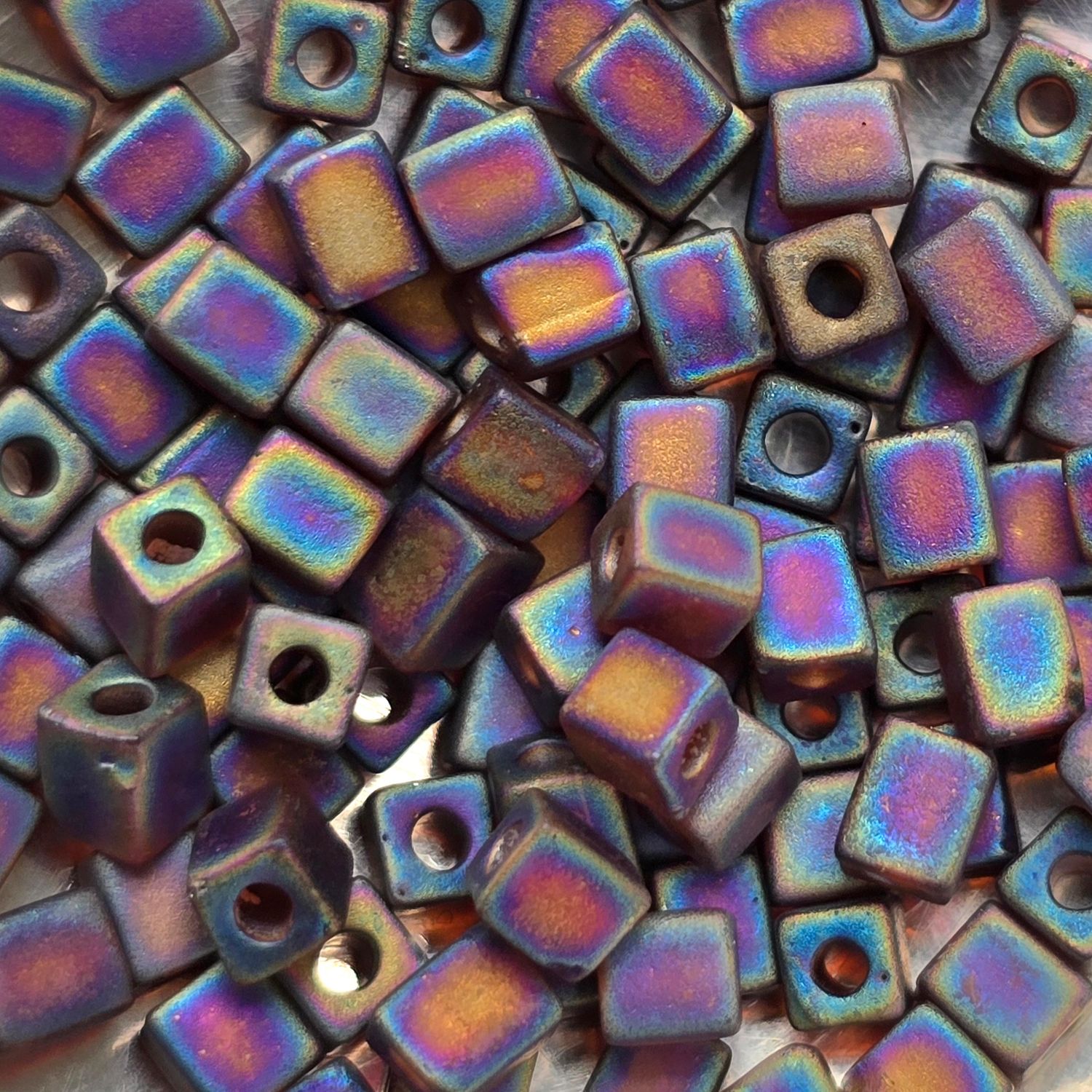SB4-134FR: Miyuki Transparent Frosted Rainbow Dark Amber - 4mm Square/Cube Beads