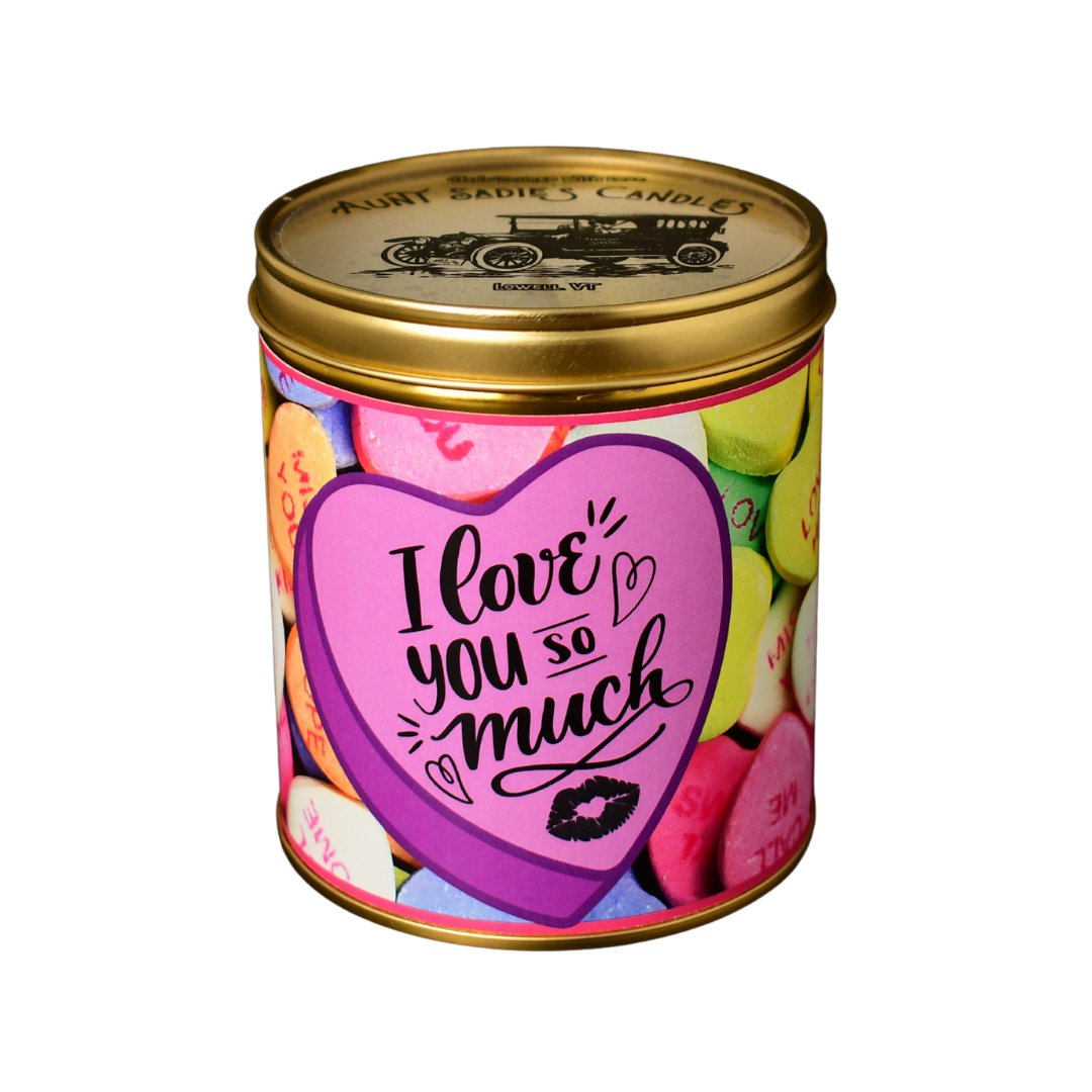 An Aunt Sadie's Candles Valentine's Day candle poured in a gold tin, with a candy hearts label that says 