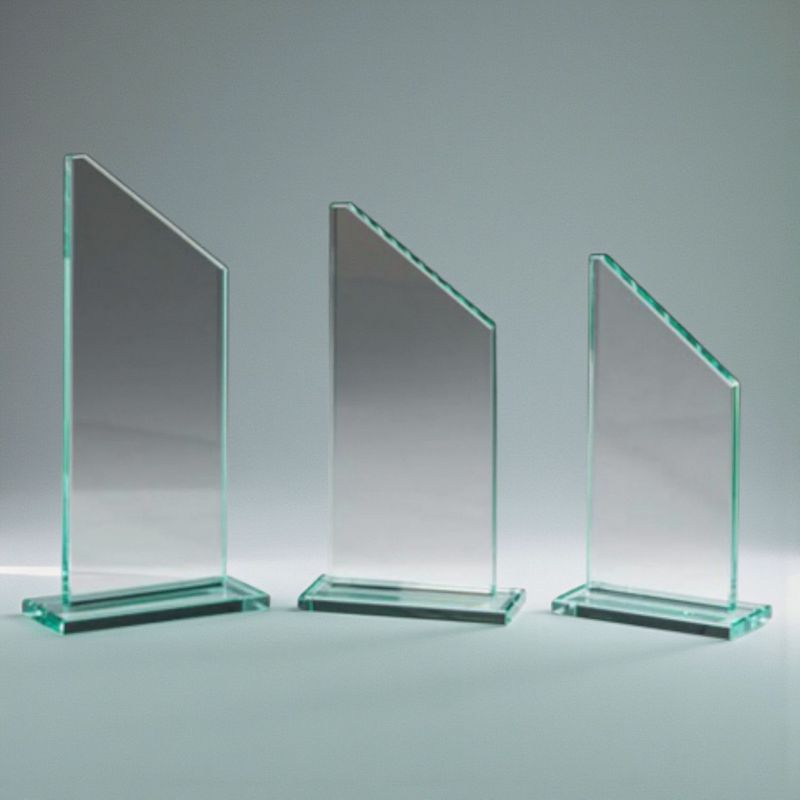 Drei Jadeglas-Trophäen mit schräger Oberkante und klarem Glassockel in unterschiedlichen Höhen, Studioaufnahme.