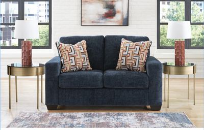Aviemore Loveseat Modern in Blue by Ashley with throw pillows