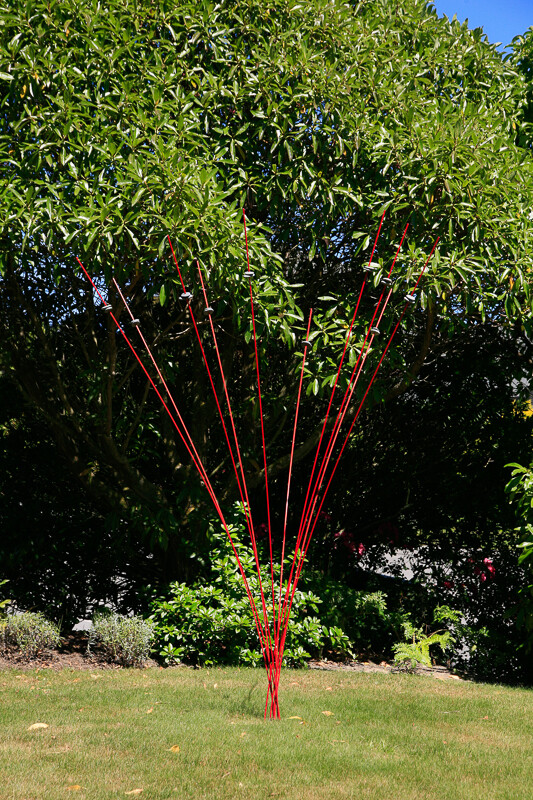 Windsticks 10x2m Red with stones, kinetic wind sculpture and bird feeder, blending artistic design with functionality for out