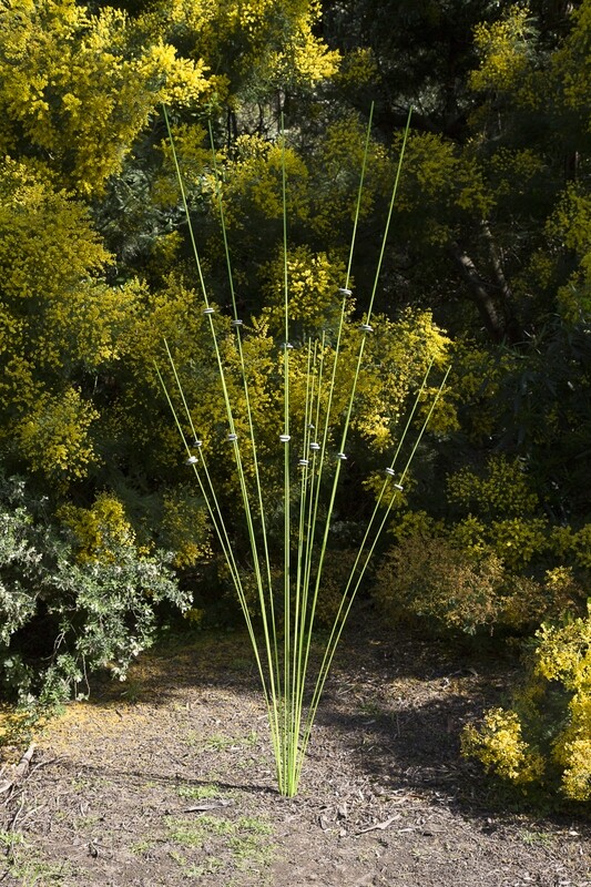 Windsticks 5x3m &amp; 10x2m in lime green with stones, showcasing innovative bird feeders and kinetic sculptures