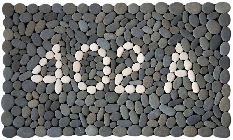 STREET NUMBER Stonemat featuring custom white stone numbers surrounded by natural grey stones in a handmade design