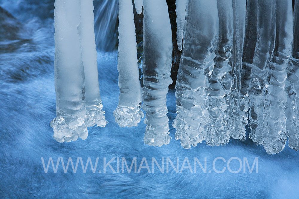 Stalactite Icicles Over a Stream – Winter’s Natural Beauty