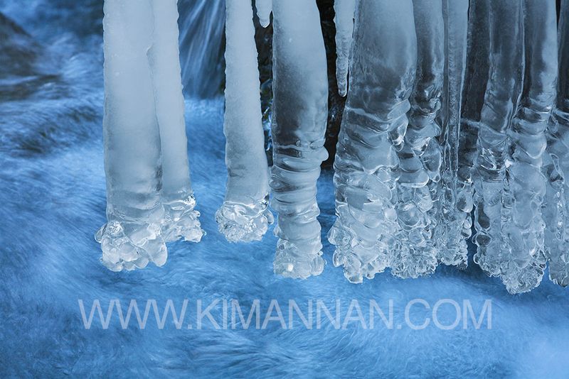 Stalactite Icicles Over a Stream – Winter’s Natural Beauty