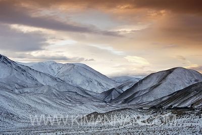 Lindis Pass at sunset with the first dusting of snow for winter, showcasing the serene beauty of the Mackenzie Basin in NZ