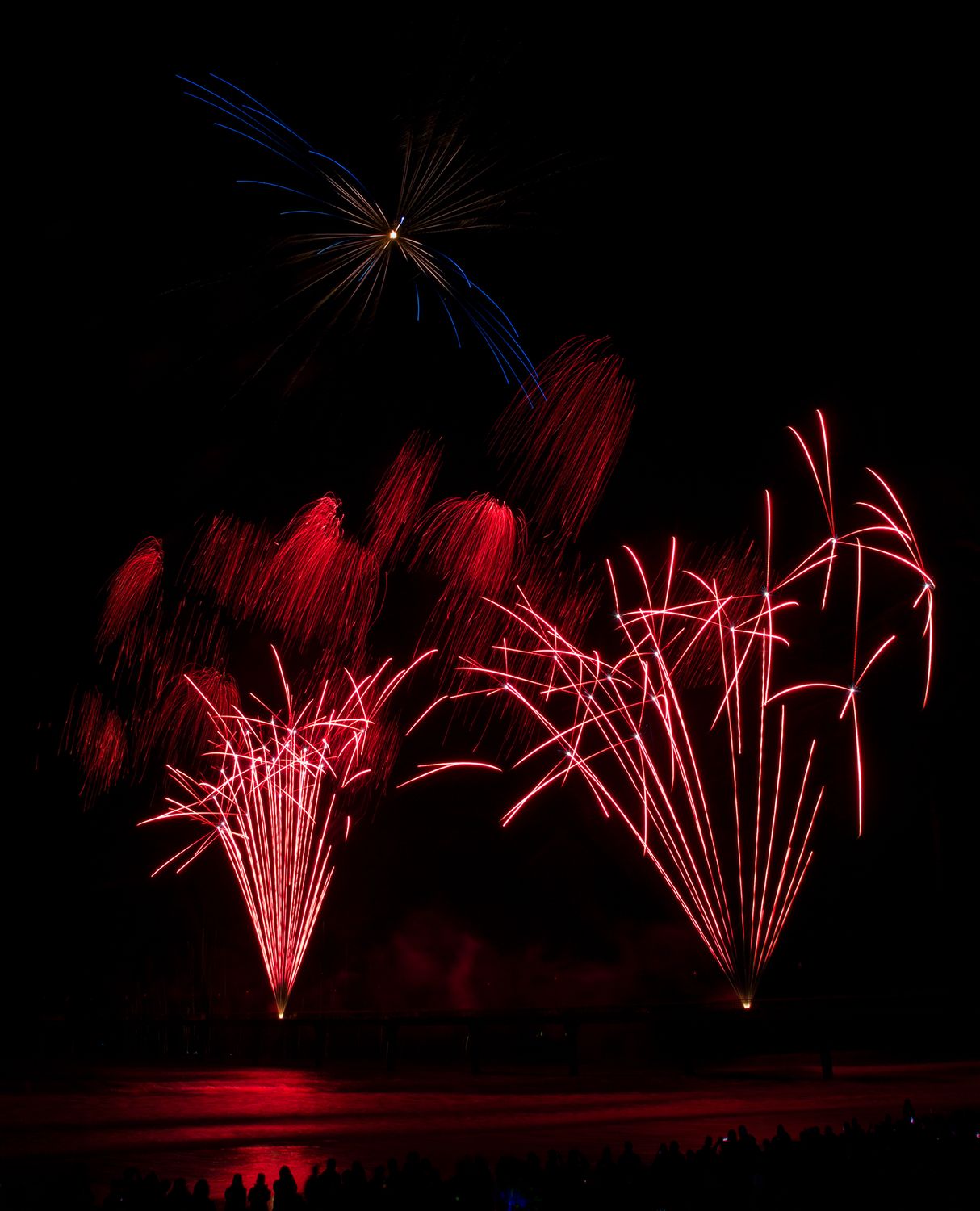 Upward red fireworks at Brighton Pier, Christchurch, New Zealand