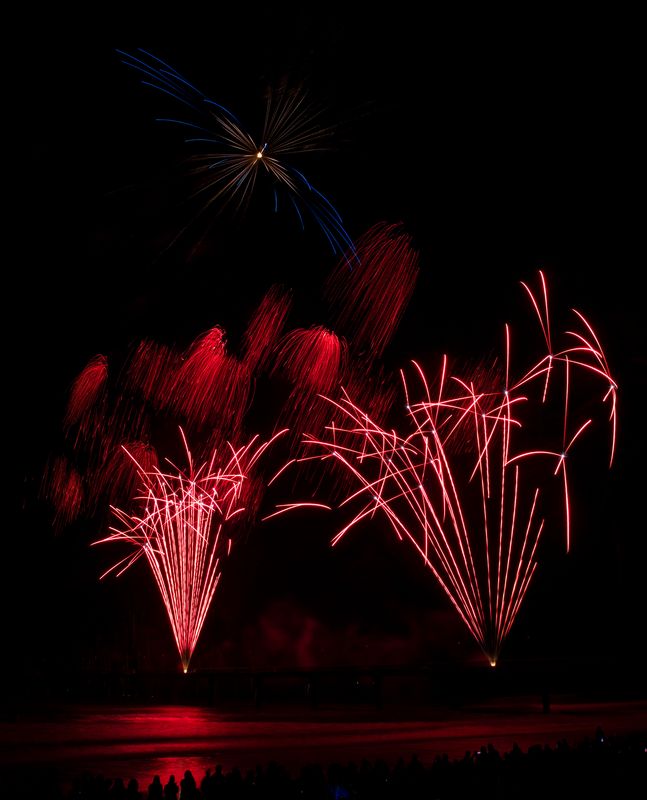 Upward red fireworks at Brighton Pier, Christchurch, New Zealand