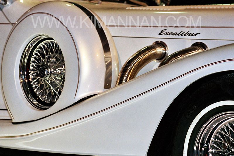 Close-up of 1982 Excalibur Phaeton with exhaust pipes and spare wheels