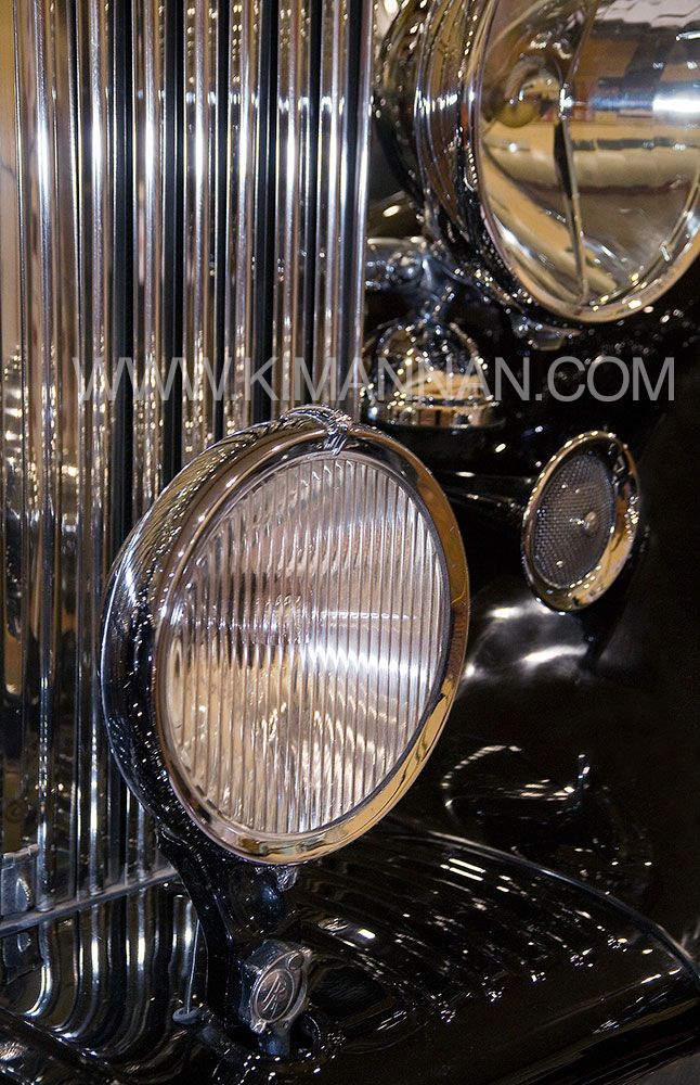 Close-up of the front grill and headlights of a black Rolls-Royce Phantom II