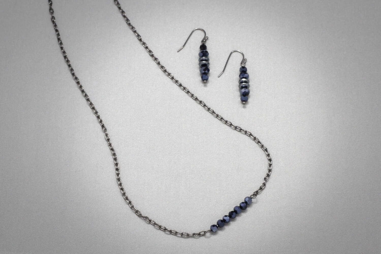 Faceted glass beads and gunmetal chain necklace and earrings