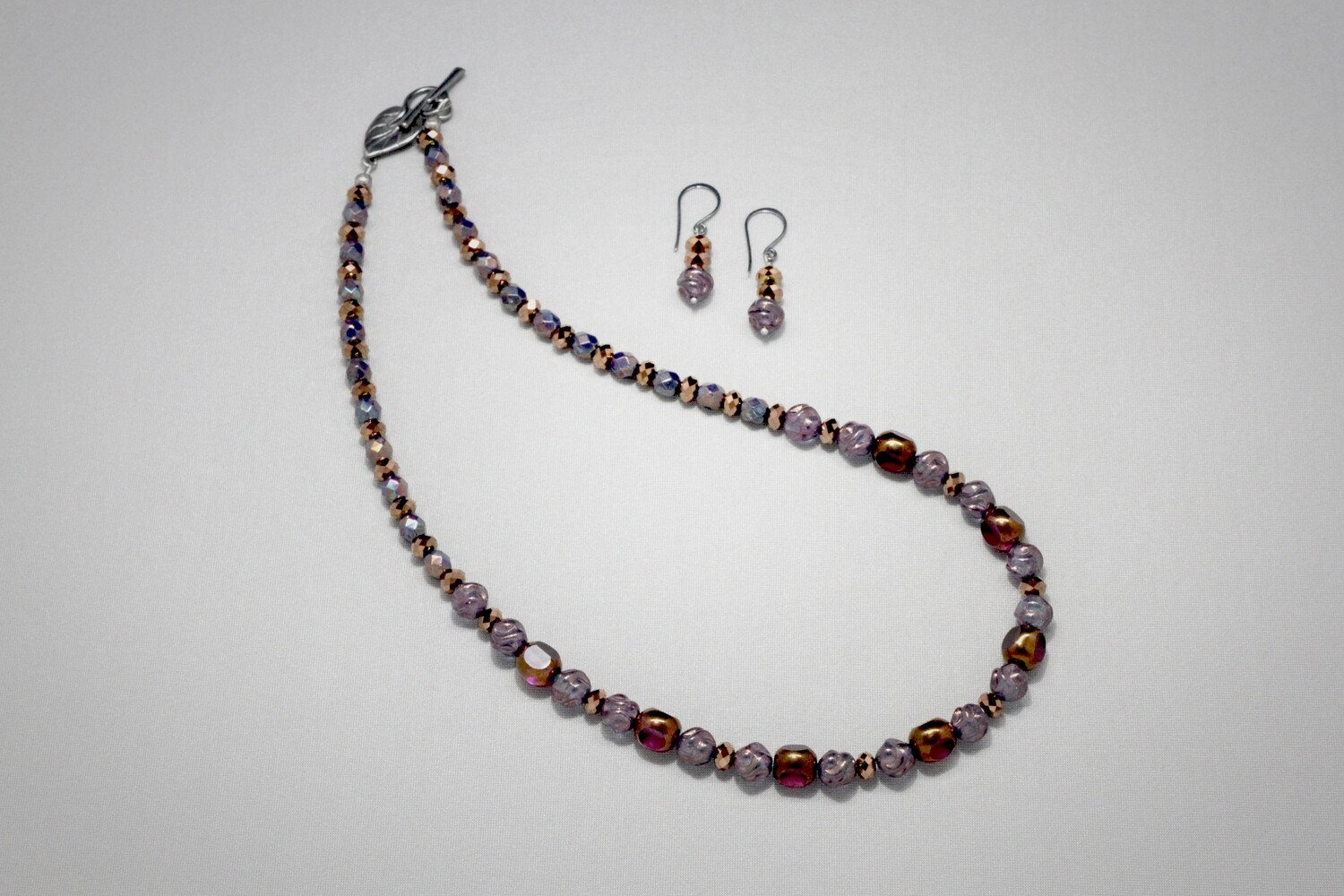 Faceted and twisted glass bead necklace and earrings