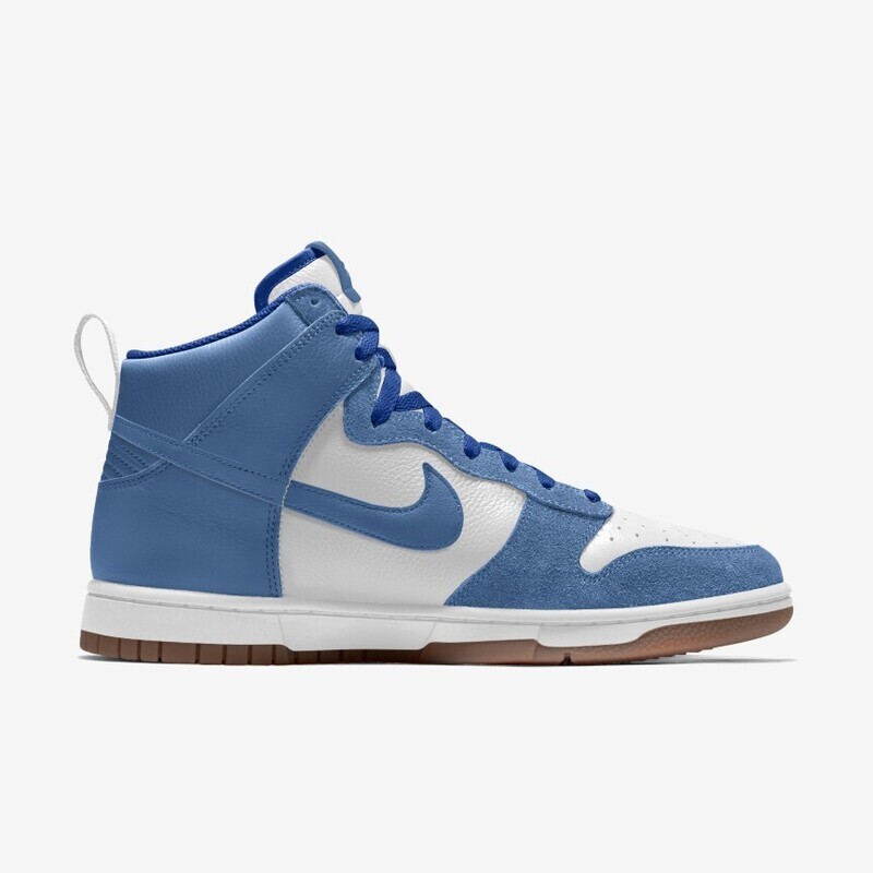 A side view of a nike dunk high sneaker in blue and white with a prominent nike swoosh logo, white laces, and a brown gum sole.