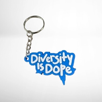 Keychain featuring a blue speech bubble design with the text &quot;diversity is dope&quot; in white letters, attached to a metal ring via a chain, on a white background.