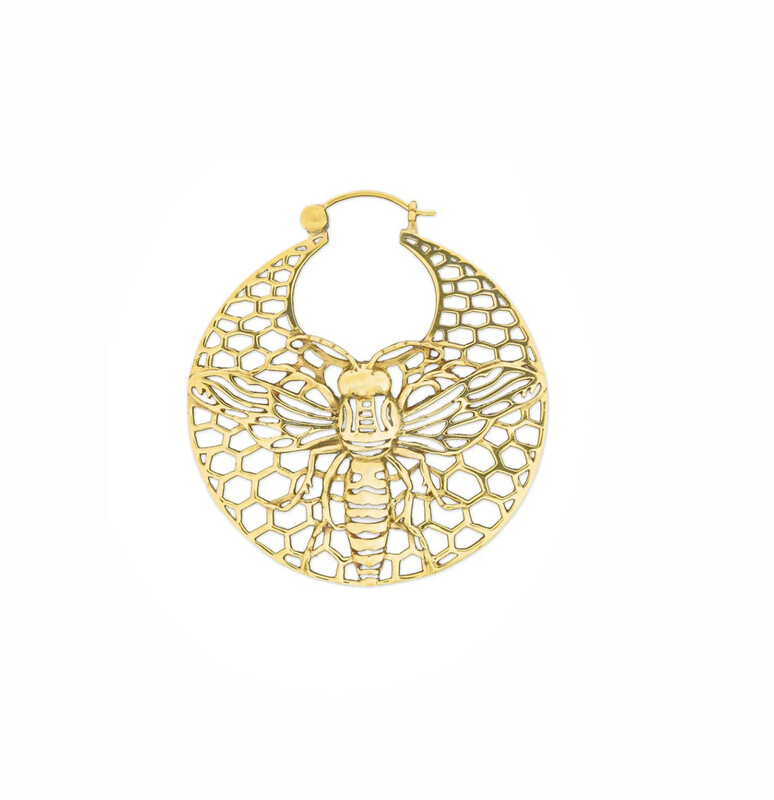 Close-up image of a gold hoop earring by Tawapa featuring a honeycomb pattern with a detailed bee design in the center. The intricate openwork showcases the bee&#39;s wings and body against the hexagonal honeycomb background.