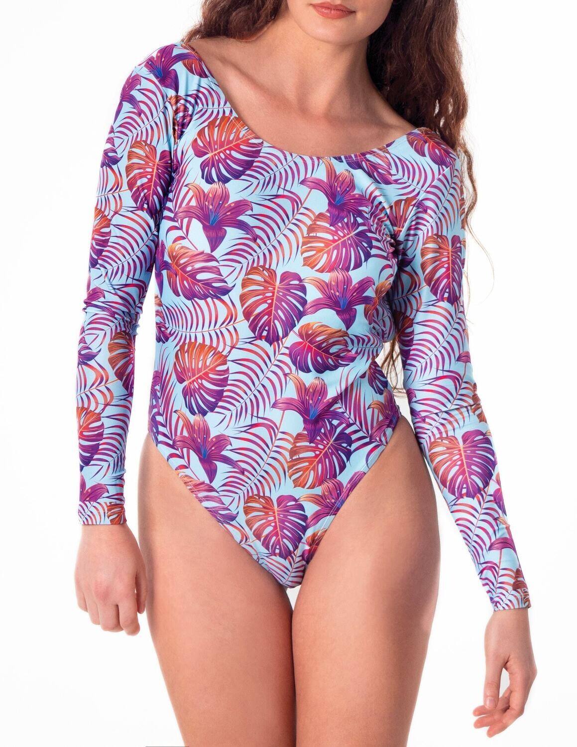 Sustainable tropical high-end long-sleeve one-piece swimsuit with open back, featuring bold purple and orange palm leaves and vibrant hibiscus blooms on a pastel light blue background worn by a woman.
