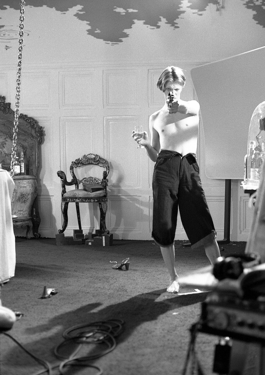David Bowie:  TMWFTE on set with pistol, 1975 - MAC056