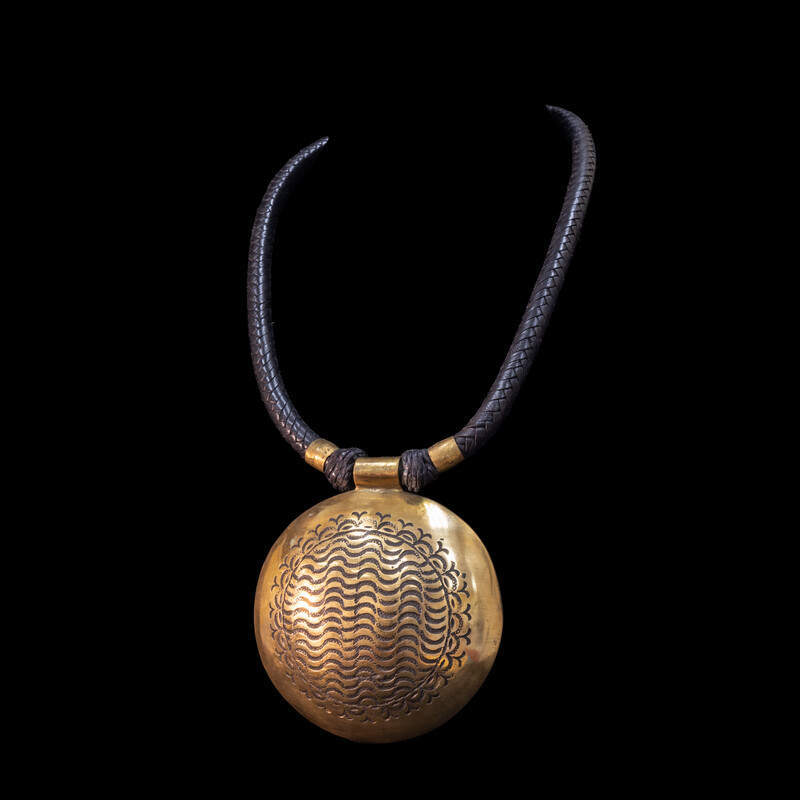 Attractive hand-made Tuareg necklace. Braided leather cord with large hand etched  brass pendant.