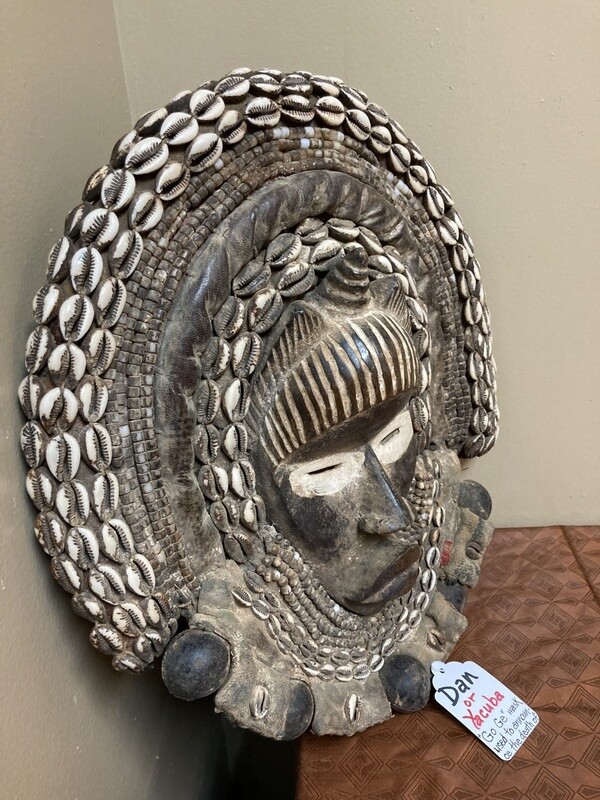 Dan (Yacuba) &quot;Go Ge&quot; mask: The job of this mask is to announce the death of the chief. The dan are found in SW ivory coast and next door in Liberia. Wood, cowrie shells, fabric, and kaolin (white colo