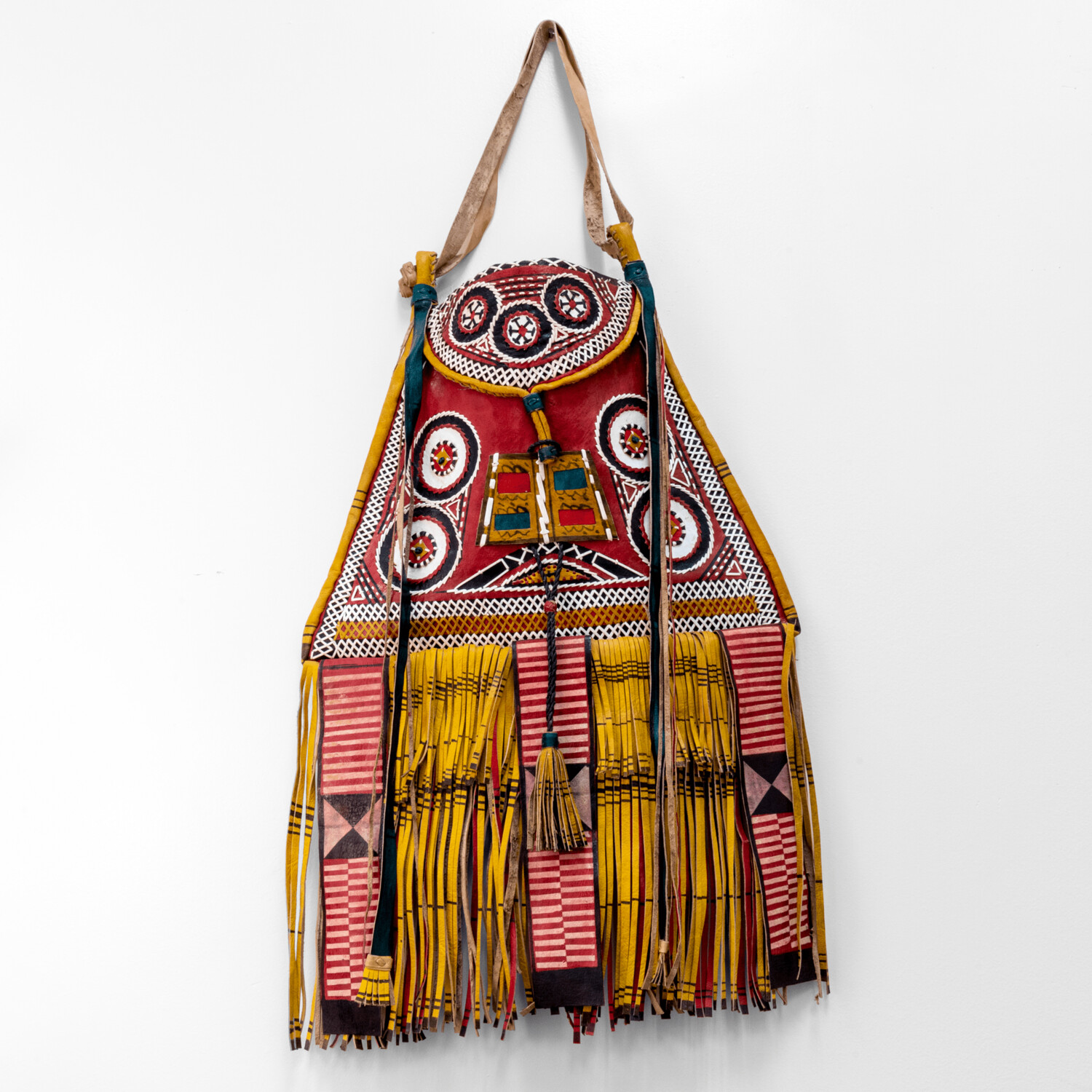 Modern take on traditional Tuareg camel leather bag. Ornate and colorful hand-made  leather bag with fringes.