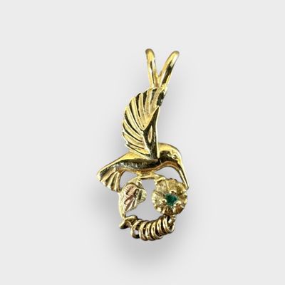10k Humming bird pendant w/ 7 movable Circles and Flower with Emerald center