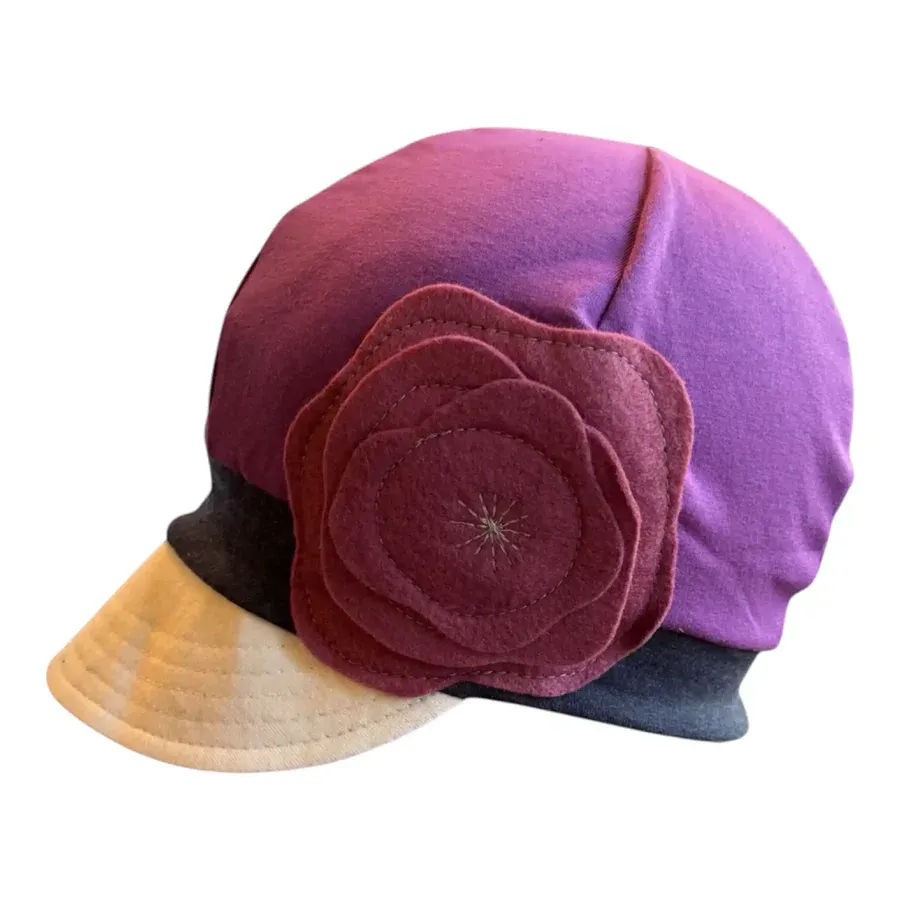 Purple stretchy cap with white brim and purple flower on side