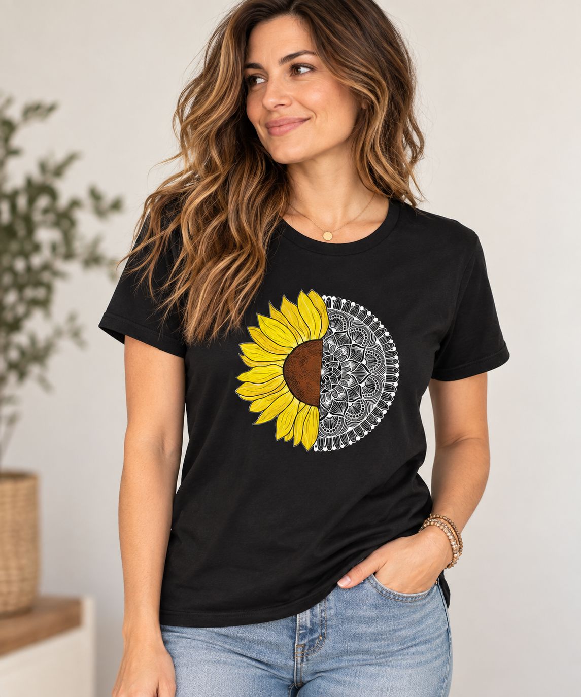 Woman wearing a black T-shirt featuring a yellow sunflower and detailed black-and-white mandala design