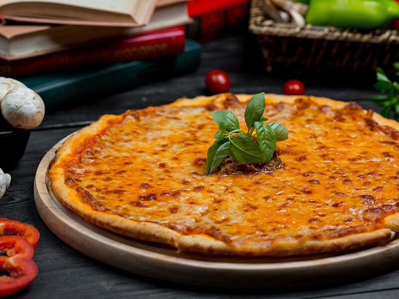 Classic Margarita Pizza with full melted cheddar and fresh basilica leaves