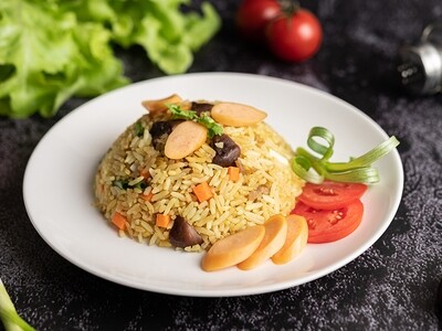Sausage Fried Rice with tomatoes, carrots and mushrooms on the plate