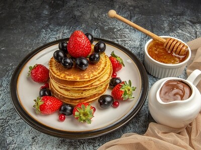 Delicious Pancakes with honey and fruits on a light surface cake sweet fruit