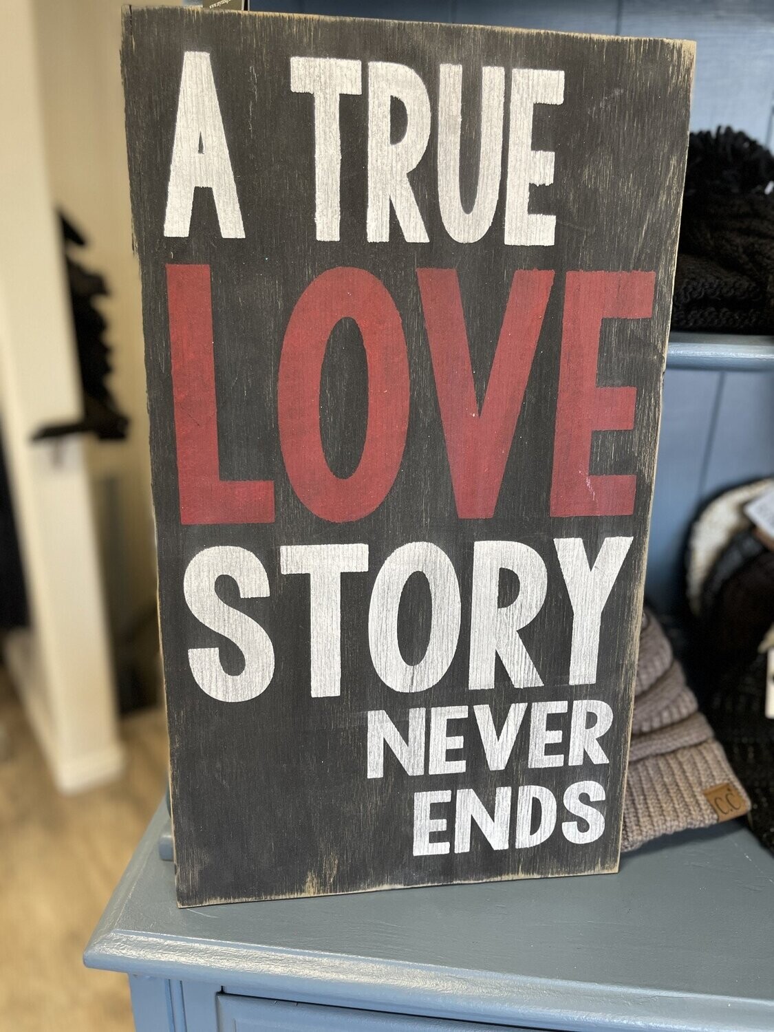 Saying &quot; A True Love Story Never Ends&quot; on  wood
