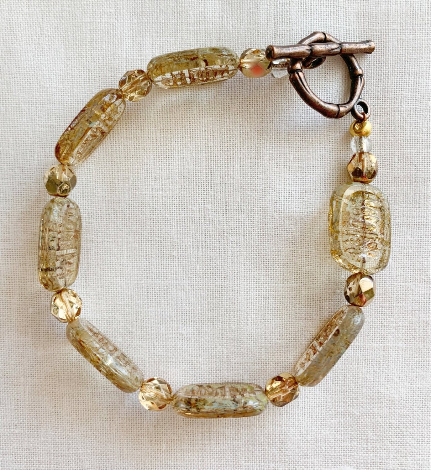 AMBER CZECH BEAD WITH BRASS TOGGLE