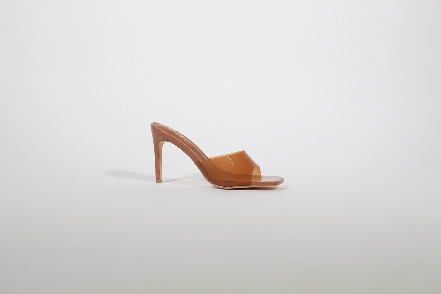 Elevate your look with the chic and cozy Moscato high heel sandals, featuring a sleek transparent design and available in Camel, black, and brown for any occasion!