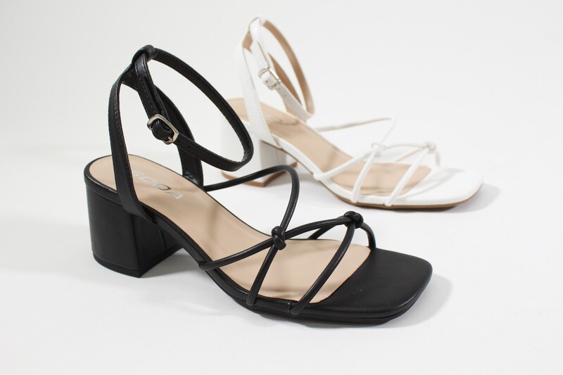 Flowing sandals with low heel and strappy design, shown in both colors, black and white for versatile styling.