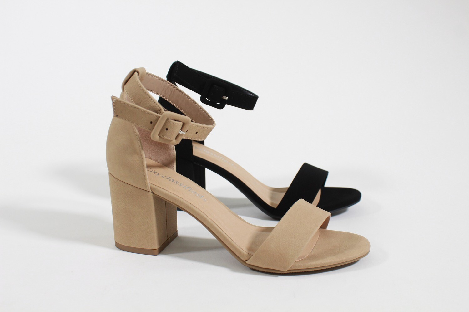 Elevate your style with Cake high heel sandals by CityClassified. These chic heels feature a classic ankle strap and a retro chunky heel. Designed with a sleek look, Cake adds sophistication to any outfit, ensuring you look and feel stunning for any occasion. Available in three colors: Black, Nude, and Silver.