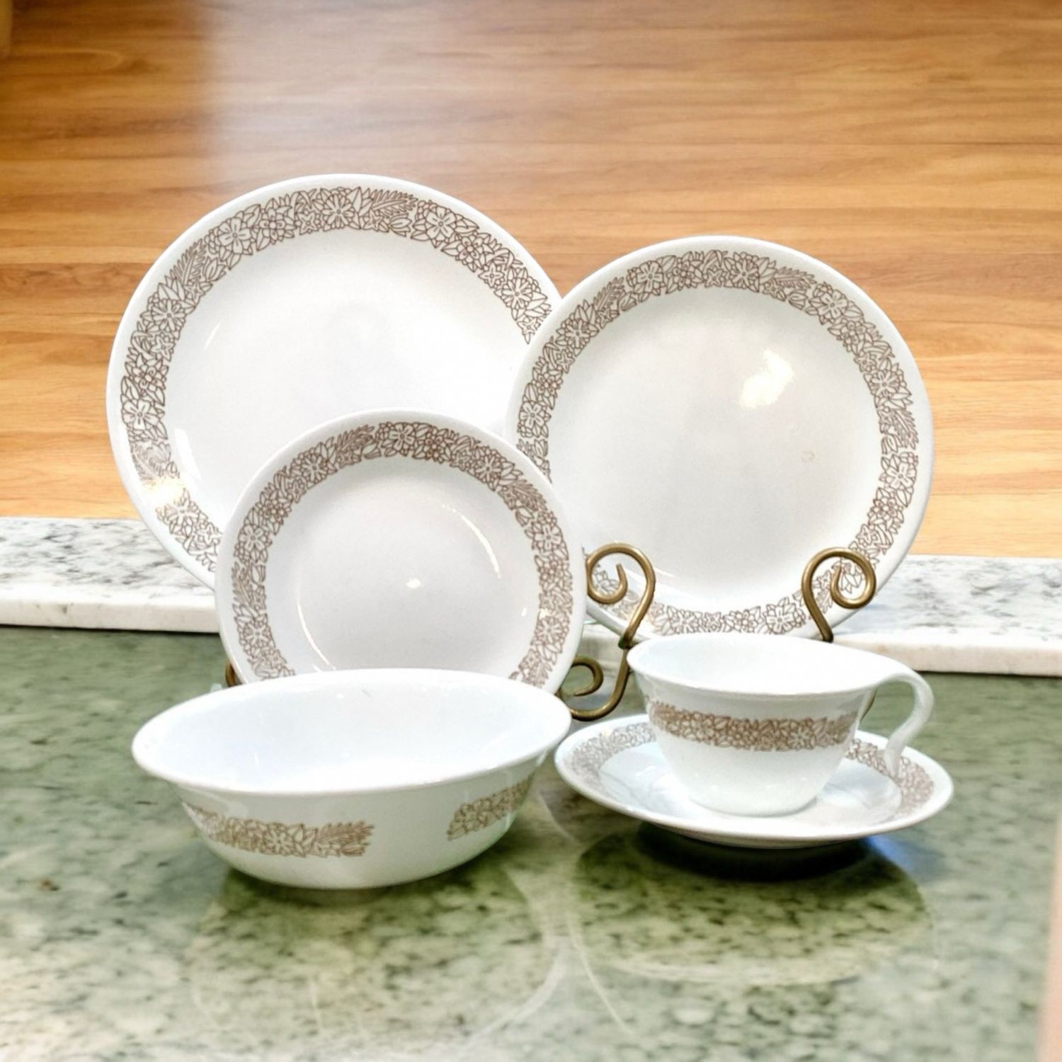 Woodland Brown by Corelle. Perfect for Thanksgiving feast and family gatherings. Each set comes with 6 pieces including dinner, salad, bread plates, teacup with saucer and Coupe Cereal Bowl. Features a delightful combination of earthy tones and intricate woodland-inspired motifs.