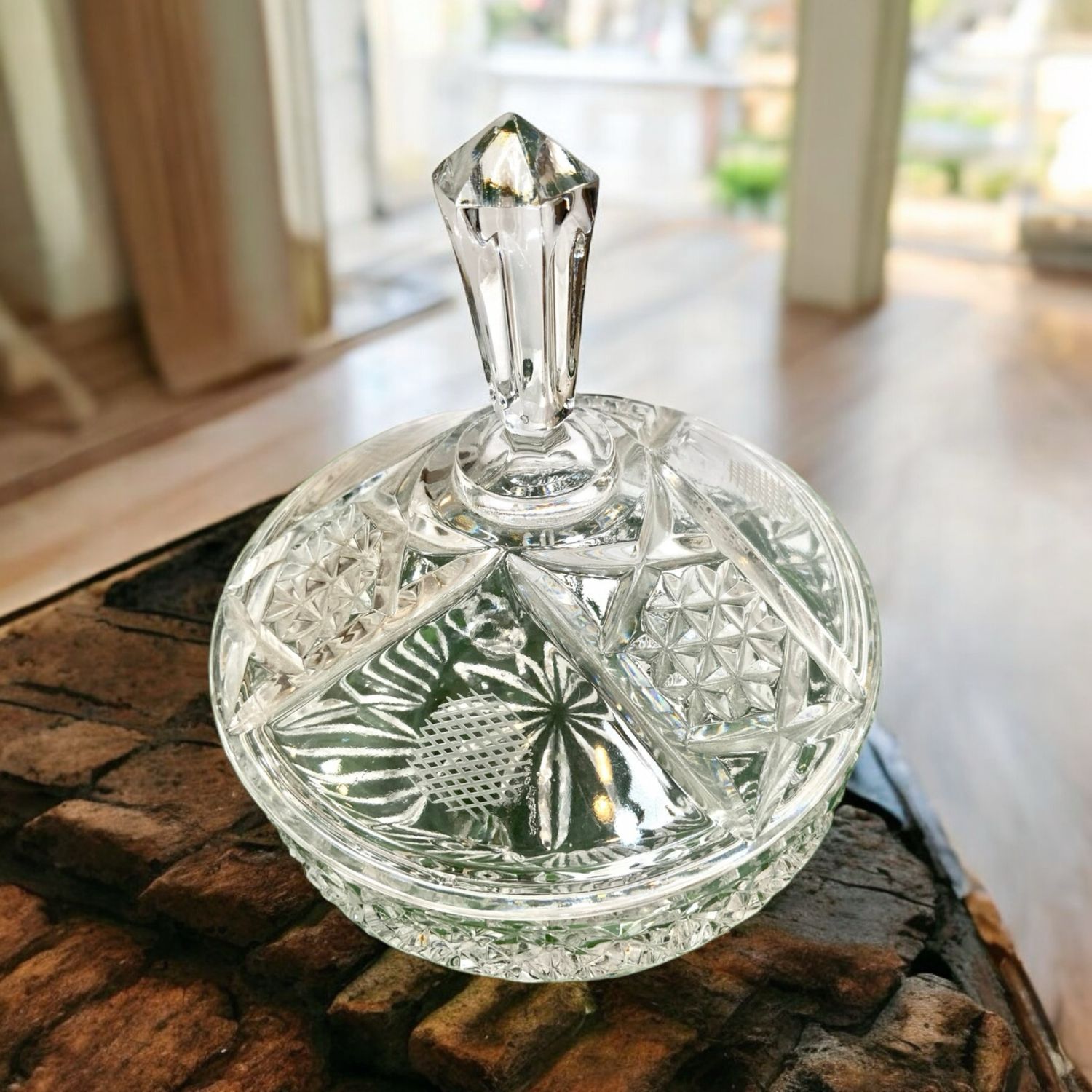 This glass footed compote with lid is versatile dish for candies, trinkets, or simply as a beautiful decorative piece. It&#39;s a charming addition to any home decor. The vintage glass candy dish with lid features an intricate flower cut design, adding elegance and nostalgia.