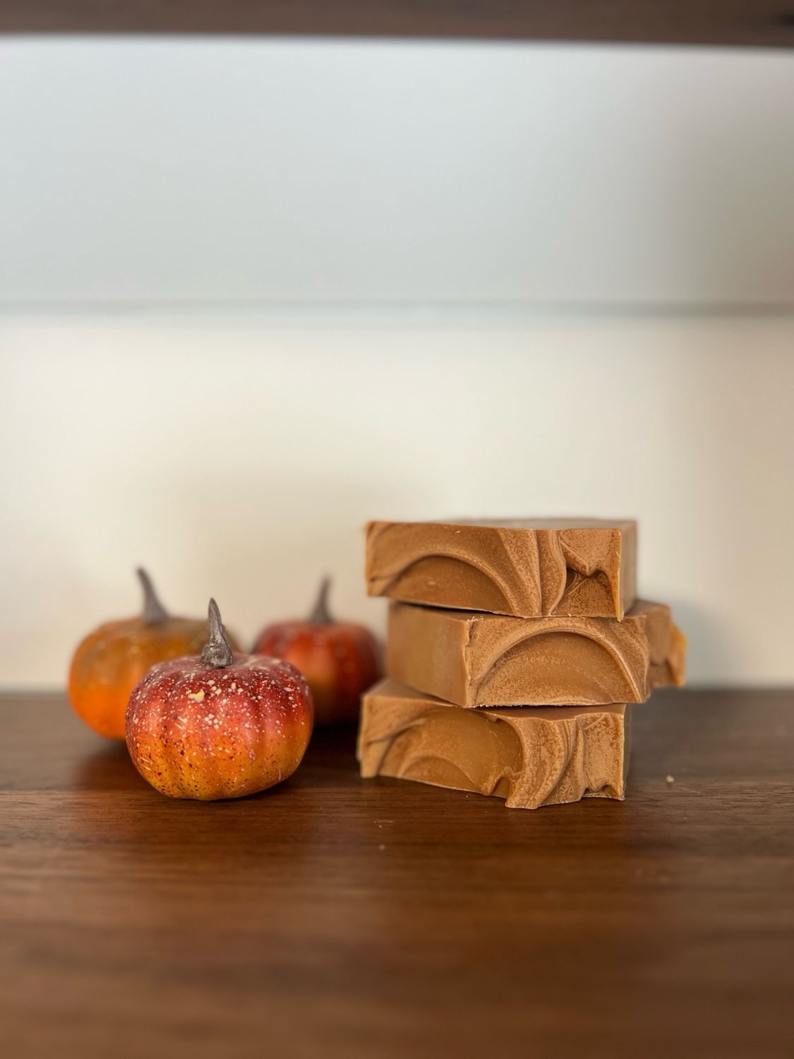 Dark orange Colored Soap Bar with decorative pumpkins displayed next to it