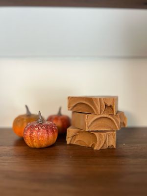 Dark orange Colored Soap Bar with decorative pumpkins displayed next to it