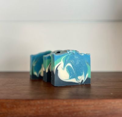 3 bars of soap colored navy, white, blue and turquoise